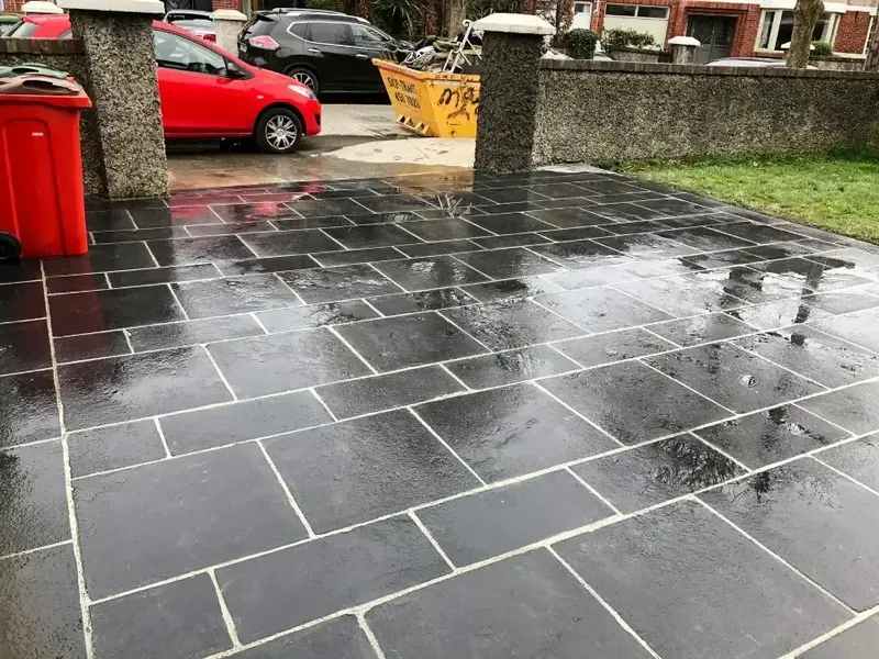 Black limestone paving in front of a Dublin house during wet weather