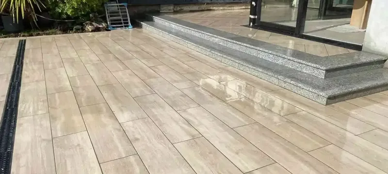Porcelain patio with granite steps after rain at a Dublin home